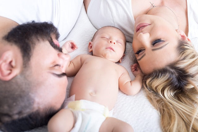 Happy mother holding newborn baby - first-time mom parenting tips